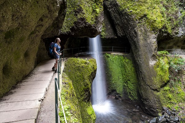 Hiker at Levada do Moinho, Waterfall in a gorge, Ponta do Sol, Madeira, Portugal, Europe