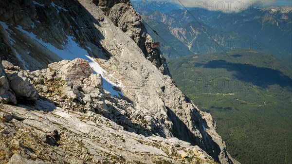 View of the descending cable car or gondola. Zugspitze massif in the bavarian alps, Dolomites, Italy, Europe