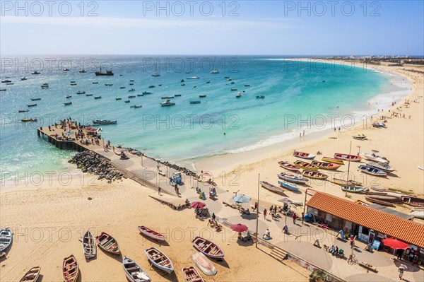 Pier and boats on turquoise water in city of Santa Maria, island of Sal, Cape Verde, Africa