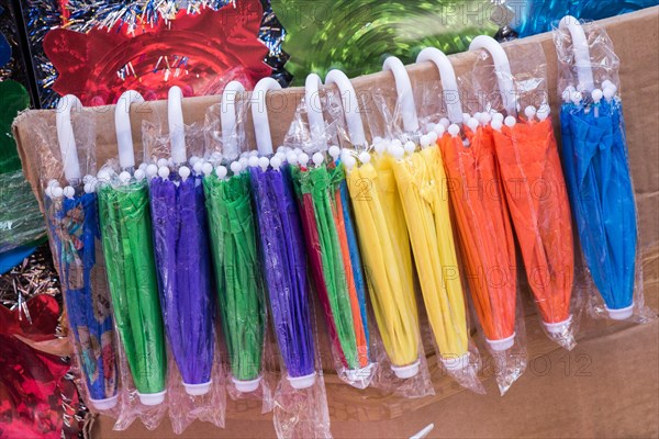 Hanging models umbrellas of various color in the market place