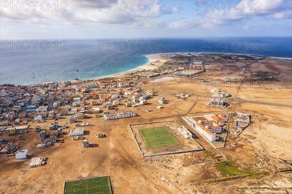 Wide aerial view on Santa Maria with the resorts on the right, African village to the left and sports field in the middle, Sal, Cape Verde Islands, Africa