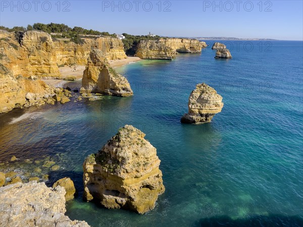 Beautiful cliffs and rock formations by the Atlantic Ocean at Marinha Beach in Algarve, Portugal, Europe