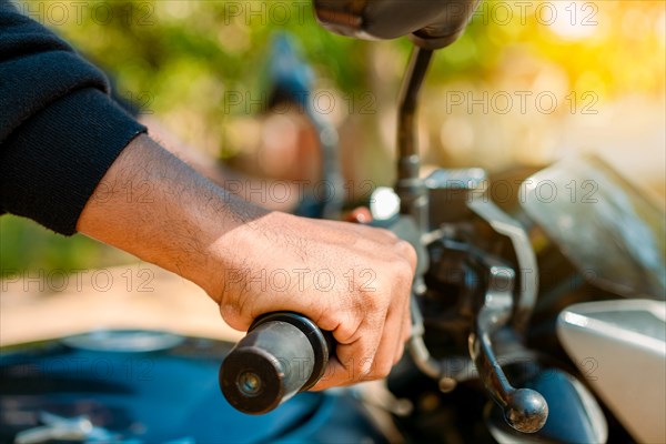 Hands of man on the motorcycle handlebars. Motorbike speeding concept, Hands of a motorcyclist on the handlebars. Close up of the hands on the handlebars of a motorcycle