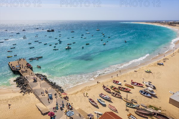 Pier and boats on turquoise water in city of Santa Maria, island of Sal, Cape Verde, Africa