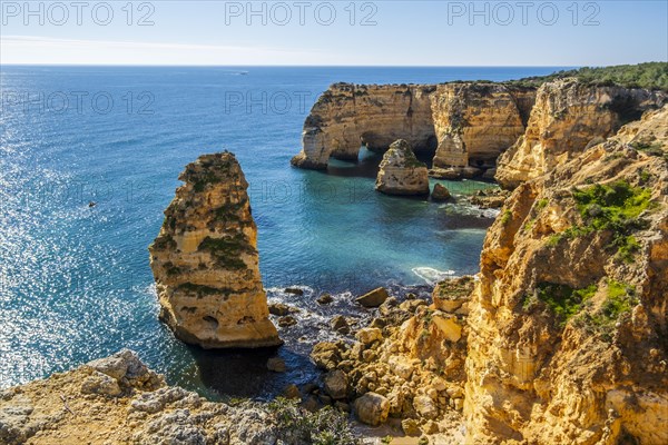 Beautiful cliffs and rock formations by the Atlantic Ocean at Marinha Beach in Algarve, Portugal, Europe