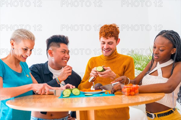Group of friends preparing vegetarian food. They prepare food and have fun in the kitchen, lifestyle