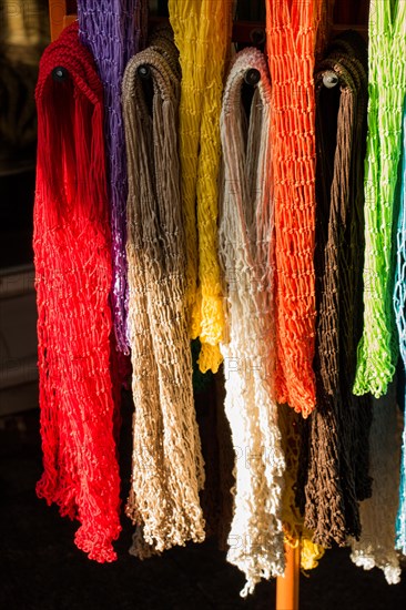 Empty mesh bags of various color at a market place