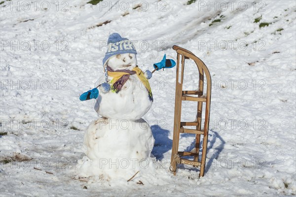 Snowman with sledge, cap and scarf, Bremen, Germany, Europe