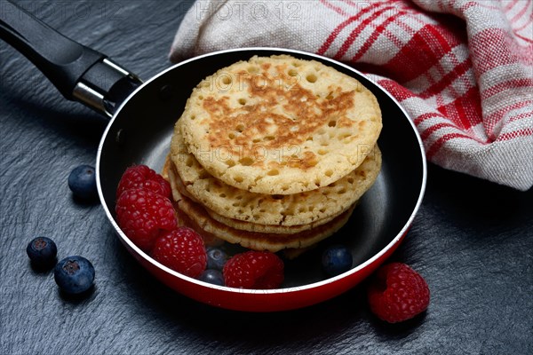 Blini, mini pancakes in pans with fruit, blini