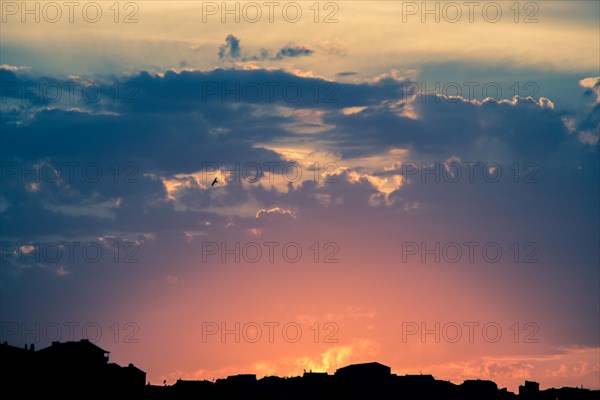 Dramatic colorful cloudy sky with picturesque clouds lit by sunset