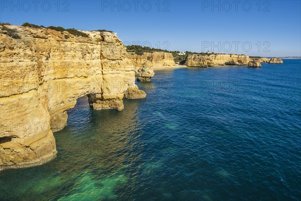 Beautiful cliffs and rock formations by the Atlantic Ocean at Marinha Beach in Algarve, Portugal, Europe