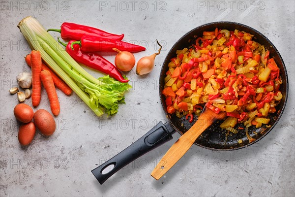 Top view of raw ingredients and ready to eat vegetable ragout