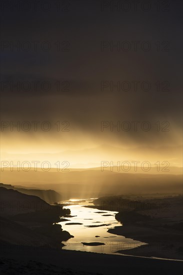 Thunderstorm over the Orange River, also known as the Orange River, on the border between Namibia and South Africa, Oranjemund, Sperrgebiet National Park, also known as Tsau ÇKhaeb National Park, Namibia, Africa