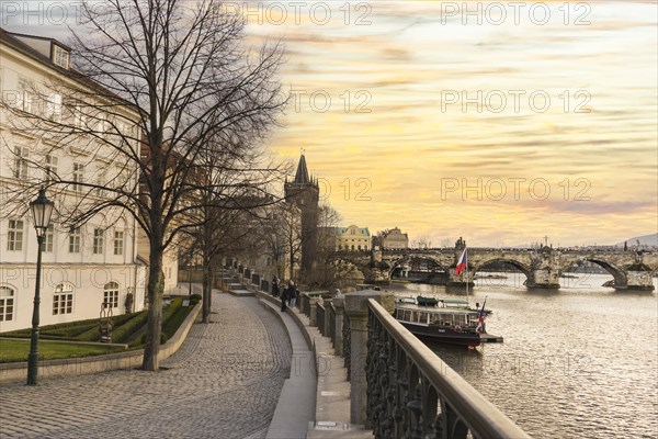 Scenic view of Charles Bridge and Moldava river at sunset in Prague, Czech Republic, Europe