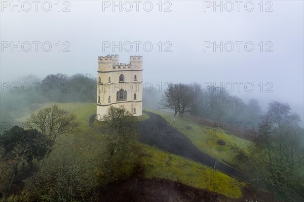 Misty morning over Haldon Belvedere from a drone, Lawrence Castle, Higher Ashton, Exeter, Devon, England, United Kingdom, Europe