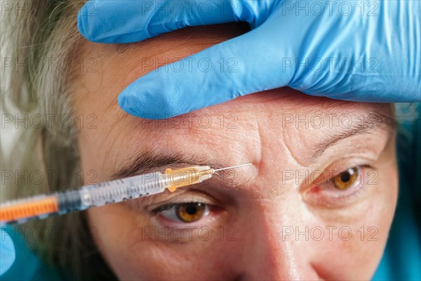 Senior woman getting skin care injection. Aged lady having botox injecting procedure. Cosmetic treatment with injection in a clinic