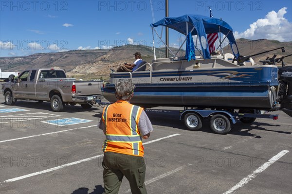 Gunnison, Colorado, Carol Soell, a boat inspector at Curecanti National Recreation Area, checks boats entering and leaving Blue Mesa Reservoir for invasive species. Colorados mandatory inspection program aims to keep zebra and quagga mussels, New Zealand mudsnails, Eurasian Watermilfoil, rusty crayfish, and waterfleas out of the states waters