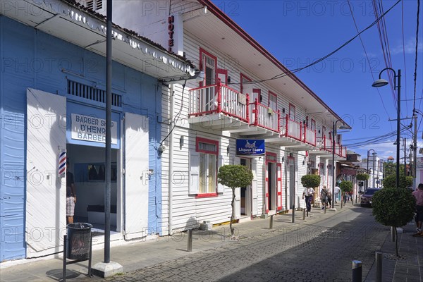 Hairdresser and liquor shop in a colonial house in the Centro Historico, Old Town of Puerto Plata, Dominican Republic, Caribbean, Central America