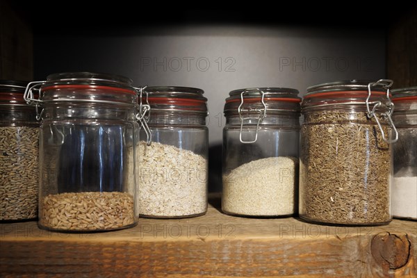 Jars with cereal grains and flakes in a bakery in Bad Urach on 25.08.2022, Bad Urach, Baden-Wuerttemberg, Germany, Europe