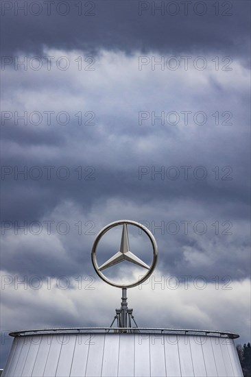 Mercedes star above the Mercedes Center in Untertuerkheim, clouds in the sky, Stuttgart, Baden-Wuerttemberg, Germany, Europe