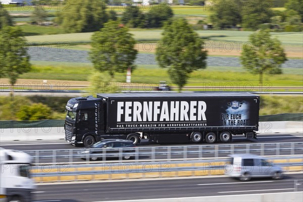 Truck with advertisement for the trade magazine Fernfahrer, on the road on the motorway, Stuttgart, Baden-Wuerttemberg, Germany, Europe