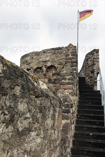 German flag of the town fortification from the 13th century, with town wall, battlements and witchs tower, Hillesheim, Rhineland-Palatinate, Germany, Europe