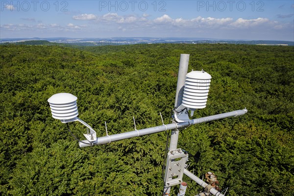 A hygrometer for recording air temperature and relative humidity hangs from a measuring tower of the Northwest German Forest Research Institute above a deciduous forest in Lower Saxony. Here, researchers are investigating how the forest can be prepared for the challenges of climate change. Mackenrode, Mackenrode, Germany, Europe