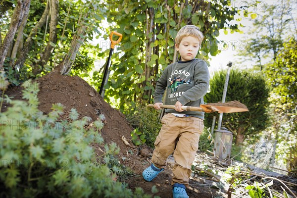 Toddler helps with gardening. Bonn, Germany, Europe