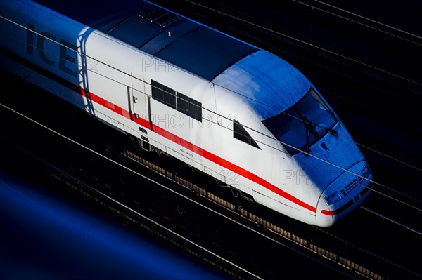 A Deutsche Bahn ICE train travels along the city railway in Berlin and is illuminated by the evening sun. Berlin, Berlin, Germany, Europe