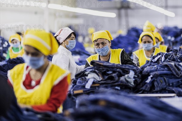 Women workers produce jeans at the Afrasyab jeans factory in Samarkand, 02.11.2022., Samarkand, Uzbekistan, Asia