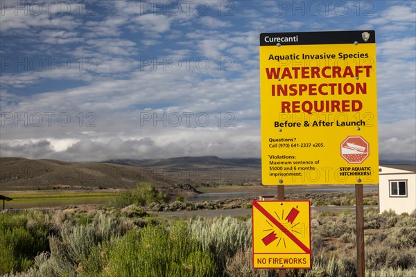 Gunnison, Colorado, A sign at Curecanti National Recreation Area warns boaters that inspections for invasive species are required at Blue Mesa Reservoir. Colorados inspection program aims to keep zebra and quagga mussels, New Zealand mudsnails, Eurasian Watermilfoil, rusty crayfish, and waterfleas out of the states waters