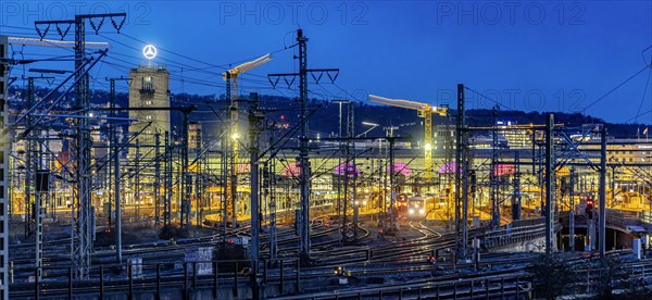 Main station in the evening, tracks and platforms are illuminated, in the background the Bonatzbau with station tower, Stuttgart, Baden-Wuerttemberg, Germany, Europe