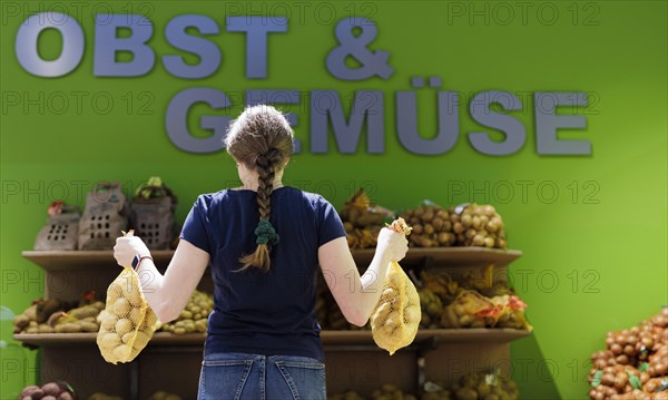 Younger woman shopping in supermarket, Radevormwald, Germany, Europe