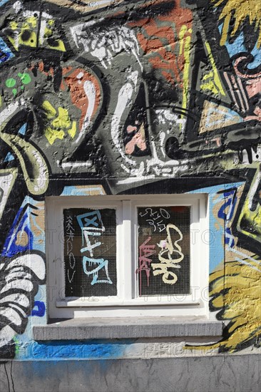 Window with colourful graffiti mural on a house wall, Bremen, Germany, Europe