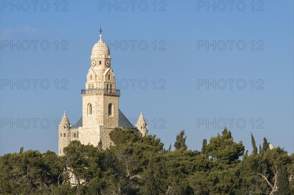 Bell tower of the Dormitio Basilica behind trees on Mount Zion, Jerusalem, Israel, Asia