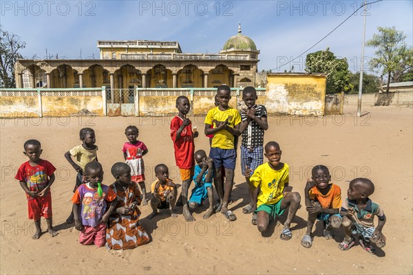 Group of African children in front of the mosque in Missirah, Sine Saloum Delta, Senegal, West Africa, Africa