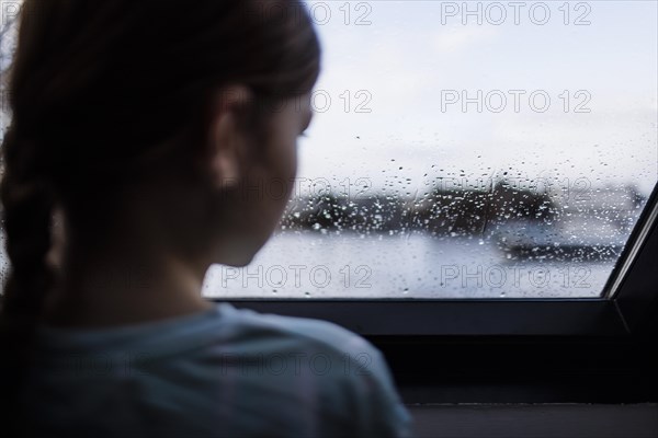 Girl looking out of the window, Bonn, Germany, Europe