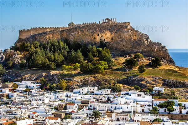 View of Lindos with white houses and Acropolis, Rhodes, Greece, Europe