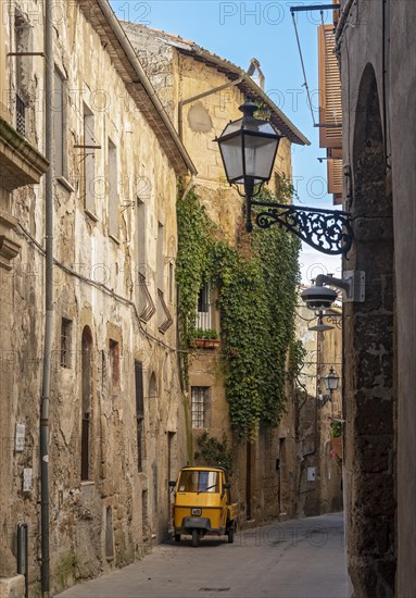 Three-wheeler in the streets of Pitigliano old town, Tuscany, Italy, Europe