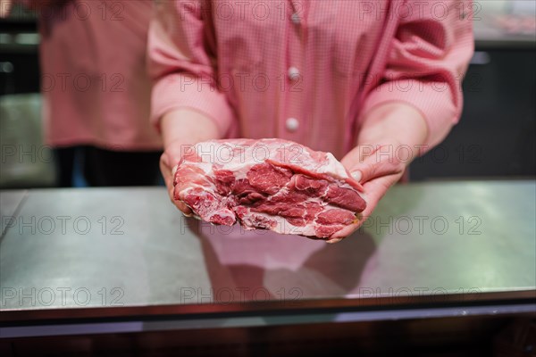 Piece of pork neck for steaks at the butcher in the supermarket, Radevormwald, Germany, Europe