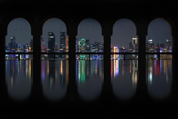 View of the illuminated skyline of Doha, Qatar, from the terrace of the Museum of Islamic Art by the archtics Ieoh Ming Pei and Jean-Michel Wilmotte, Asia