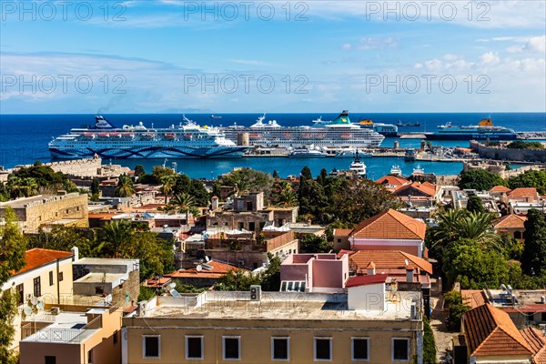 View of Mandraki harbour with cruise ships, Rhodes Town, Greece, Europe