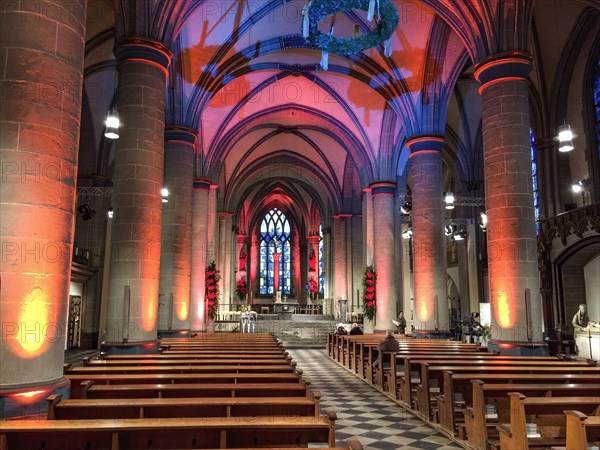 Festively lit interior central nave of Essen Cathedral Muenster former collegiate church cathedral church bishop's seat Ruhrbistum diocese Essen, Advent wreath hung on top, Essen, North Rhine-Westphalia, Germany, Europe