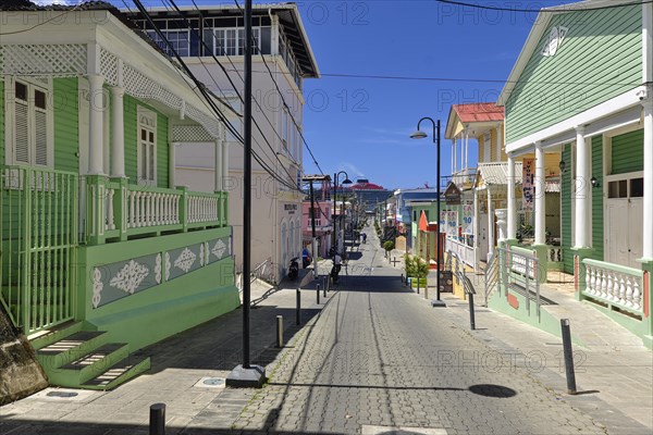 Colonial houses, Calle Duarte, chimney with exhaust fumes of the cruise ship Scarlet Lady, shipping company Virgin Voyages, in the port of Puerto Plata, Dominican Republic, Caribbean, Central America