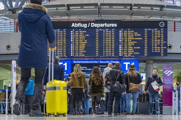 Airport terminal with departure indicator board, departure, travellers with suitcases, interior shot, Airport Echterdingen, Stuttgart, Baden-Wuerttemberg, Germany, Europe