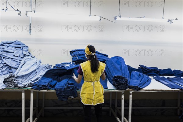 A worker sorts jeans at the Afrasyab jeans factory in Samarkand, 02.11.2022., Samarkand, Uzbekistan, Asia