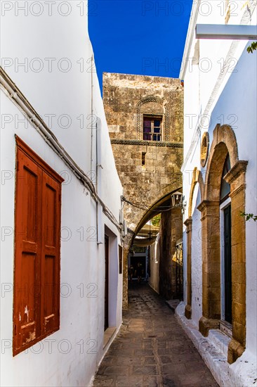 Captains house in the winding streets with white houses, Lindos, Rhodes, Greece, Europe