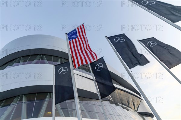 The American flag flies in front of the Mercedes Museum, Mercedes-Benz Group AG, Stuttgart, Baden-Wuerttemberg, Germany, Europe