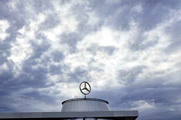 Mercedes star above the Mercedes Center in Untertuerkheim, clouds in the sky, Stuttgart, Baden-Wuerttemberg, Germany, Europe