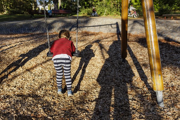 Child on a swing. Bonn, Germany, Europe